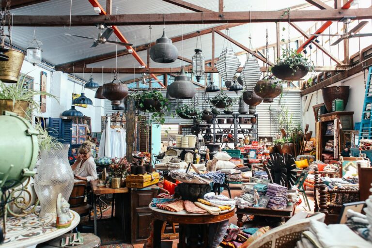 Explore a vibrant indoor market featuring eclectic decorations, textiles, and plants in a cozy atmosphere.